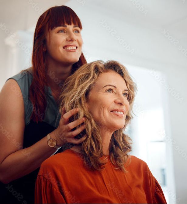 Photo of woman and stylist talking and smiling