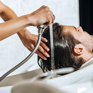 Man getting conditioning hair treatment